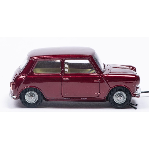 387 - A Corgi Toys Morris Mini-Minor (226). In metallic maroon with lemon interior and detailed cast wheel... 