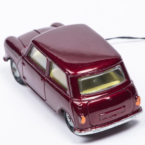 387 - A Corgi Toys Morris Mini-Minor (226). In metallic maroon with lemon interior and detailed cast wheel... 