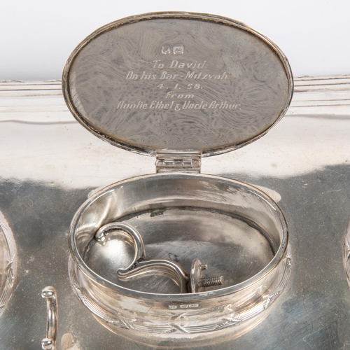 19 - A silver ink and pen stand. Hallmarked for James Deakin & Sons, Sheffield, 1916 on the tray, with 5 ... 