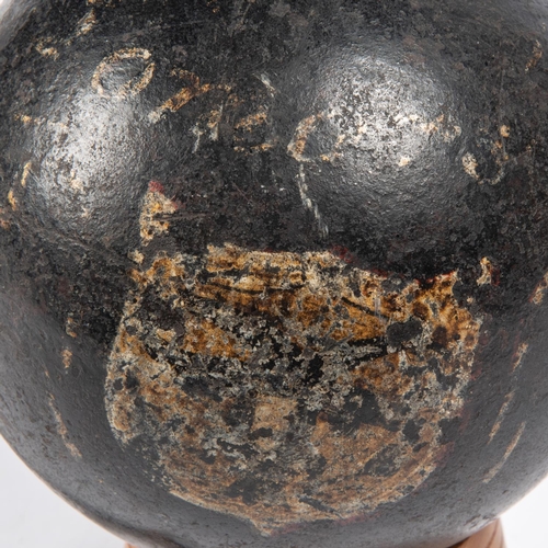 264 - A large iron explosive cannon ball, bearing traces of painted armorial shield and inscribed 