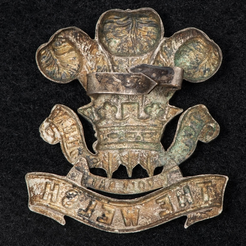 287 - A white metal cap badge of the 1st Volunteer Battalion the Welsh Regiment, with blades. GC (appears ... 