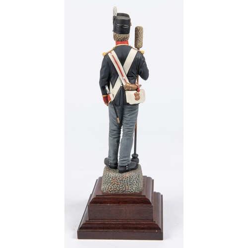 37 - A good Charles Stadden figurine of a Waterloo Period Gunner, with polished wood base, height 12