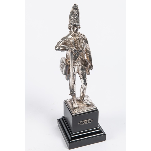 46 - A good silver figurine of a 1745 Grenadier, mounted on an ebonised plinth, London HM on base, height... 