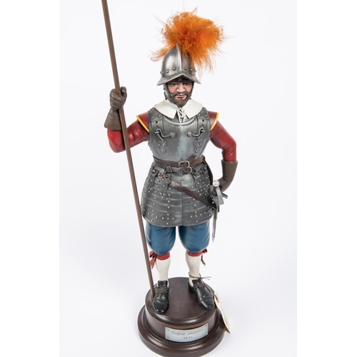 49 - A decorated figure of a Cromwellian pikeman c 1645, with applied armour and weapons, mounted on a po... 