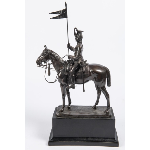 52 - A bronzed composition equestrian figure of a mounted lancer, with lance cap, sword and lance, on rec... 