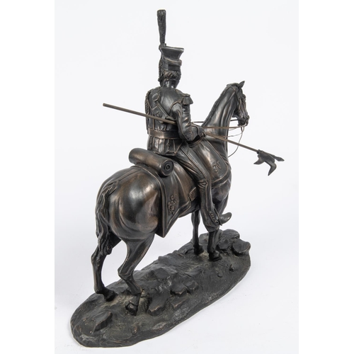 53 - A bronzed composition equestrian figure of a French Napoleonic period mounted lancer, with lowered l... 