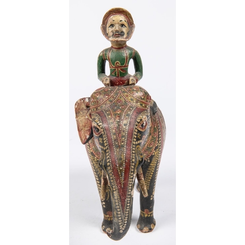 55 - A 19th Century carved wood figure of an elephant with mahout, colourfully decorated with paint and g... 