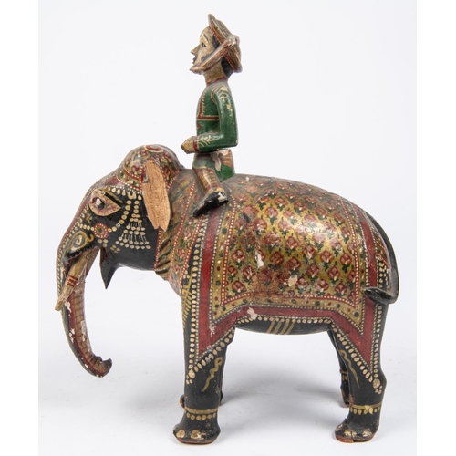 55 - A 19th Century carved wood figure of an elephant with mahout, colourfully decorated with paint and g... 