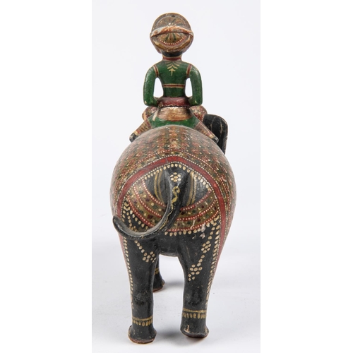 55 - A 19th Century carved wood figure of an elephant with mahout, colourfully decorated with paint and g... 