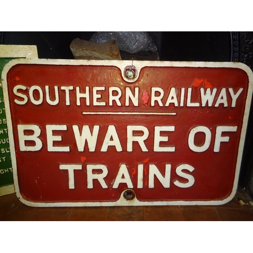 82 - A Southern Railways cast iron 'Beware of Trains' sign. Measures: 56cm x 42cm. White lettering on red... 