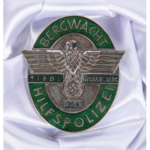 111 - A Third Reich silvered and enamelled badge “Bergwacht Hilsfpolizei Tirol Vorarlberg” numbered 251, 6... 