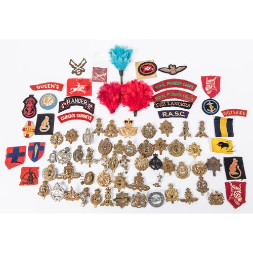 160 - Approximately 50 Corps cap badges (a few worn or AF); approximately 30 cloth titles and patches; 3 f... 