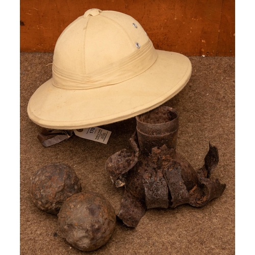 170 - A US tropical helmet, 2 cannon balls, an exploded shell, a combination gun tool and 2 shooting stick... 