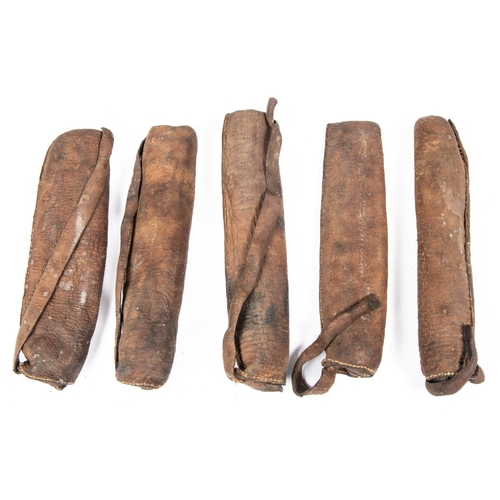 392 - Five small 18th century Indian hide quivers, probably for crossbow bolts, average 9