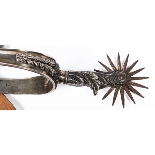 412 - A pair of historically interesting mid 19th century Mexican silver spurs, with deeply embossed folia... 