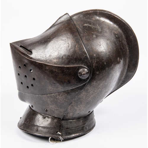 419 - A good old copy of a close helmet, c 1600, of heavy construction, the skull and low comb formed in t... 