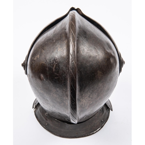 419 - A good old copy of a close helmet, c 1600, of heavy construction, the skull and low comb formed in t... 