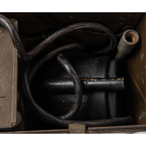 152 - A WWII British Army Electric Morse signalling lamp, in its steel and webbing case complete with 4 pa... 