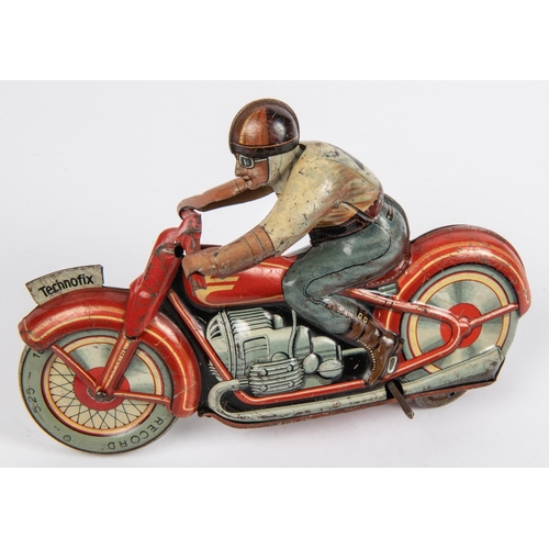 321 - A scarce Technofix tinplate clockwork racing motorcycle and rider. In red, 'G.E.258' registration nu... 