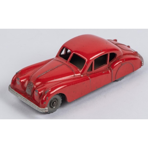 438 - Matchbox Series Jaguar XK140 No.32. An example in bright orange-red with grey plastic knobbly wheels... 