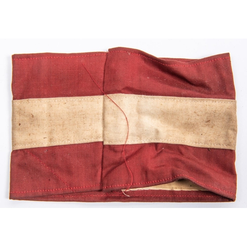 105 - A Third Reich Hitler Youth red and white armband, with applied swastika motif and gilt central pip. ... 