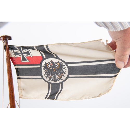 64 - An Imperial German nautical desk ornament in the form of a partly rigged mast flying naval ensign, v... 