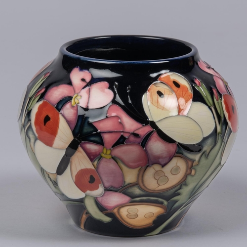 10 - A small Moorcroft pottery vase from 2019. With butterflies and honesty design on purple ground by Em... 