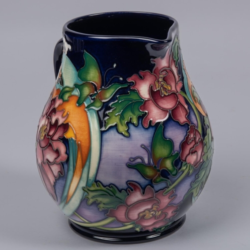 12 - A large Moorcroft pottery jug from 2008. With multi-colour foral design on a purple ground. Marks et... 