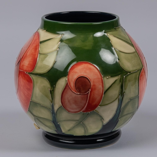 13 - A Moorcroft pottery globular vase. With stylised floral design on a green base. Marks etc to base an... 