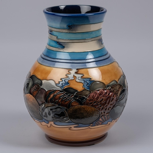 15 - A Moorcroft pottery vase. With stylised scene of streams and rocks, etc. Impressed marks etc to base... 