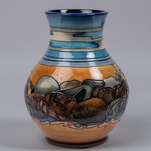 15 - A Moorcroft pottery vase. With stylised scene of streams and rocks, etc. Impressed marks etc to base... 