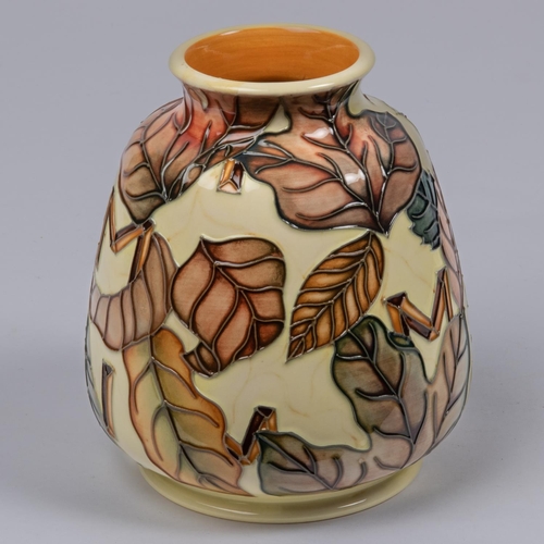 20 - A Moorcroft pottery vase. With autumn leaves and Roman numerals on yellow ground. Marks to base, CES... 