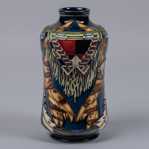 25 - A Moorcroft pottery vase. With Native American decoration on dark blue ground. Marks to base, PH, mu... 