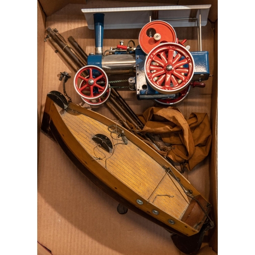 257 - A Wilesco live steam Traction Engine in blue, white and red. Together with a small wooden pond yacht... 