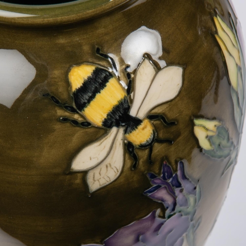 27 - A Moorcroft pottery slim vase. Bees with flowers on graded green ground. Marks to base, leaf date cy... 