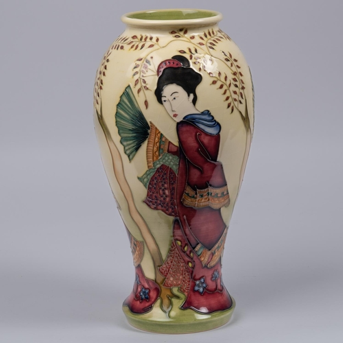 28 - A Moorcroft pottery vase. With Japanese figures on a cream ground. Marks to base, HM, eye date cyphe... 