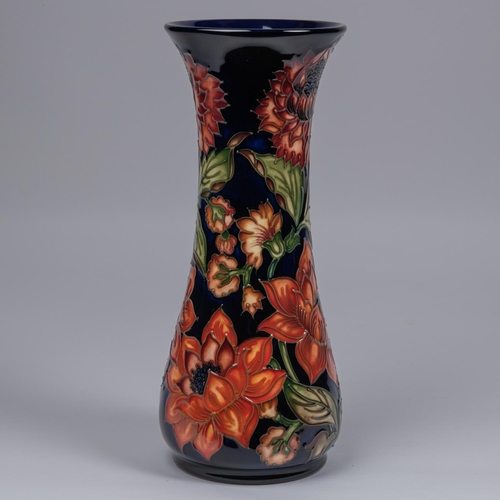 31 - A Moorcroft pottery vase. With orange flowers on dark blue ground. Marks to base, SP, jug date cyphe... 