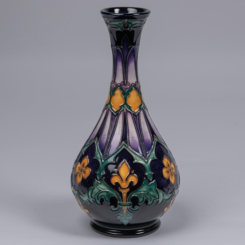 32 - A Moorcroft pottery vase. With fleurs-de-lys and acanthus leaf design on dark purple ground. Marks t... 