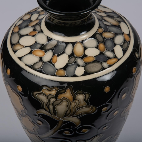 33 - A Moorcroft pottery large vase. Brown flowers on black ground designed by Marie Penkethman. Marks to... 