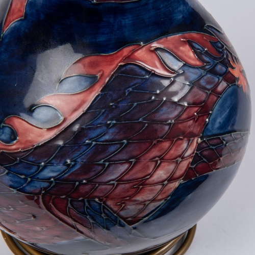 36 - A Moorcroft pottery lamp vase. With Chinese dragon on dark blue ground. Impressed marks to base. H.3... 