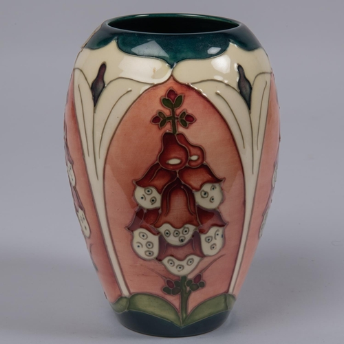 39 - A Moorcroft pottery vase. Trial vase of foxgloves in panels. Impressed marks to base, TRIAL, dated 1... 