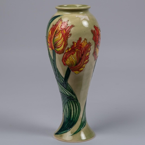 41 - A Moorcroft pottery slim vase. Parrot tulips on a green ground. Impressed marks to base, GP, candles... 