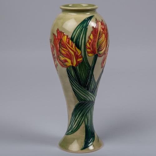 41 - A Moorcroft pottery slim vase. Parrot tulips on a green ground. Impressed marks to base, GP, candles... 