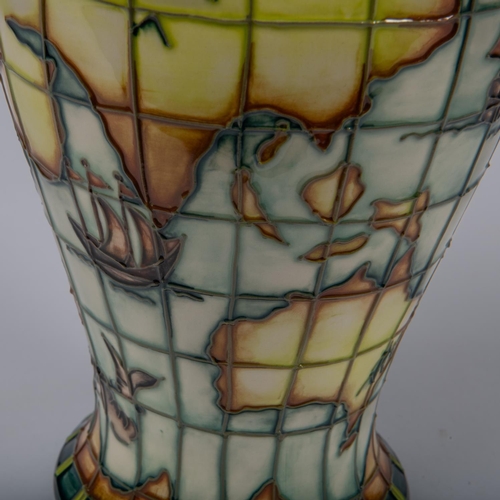 46 - A Moorcroft pottery tall vase. With world map, nautical designs, fantasy creatures, etc. Impressed m... 