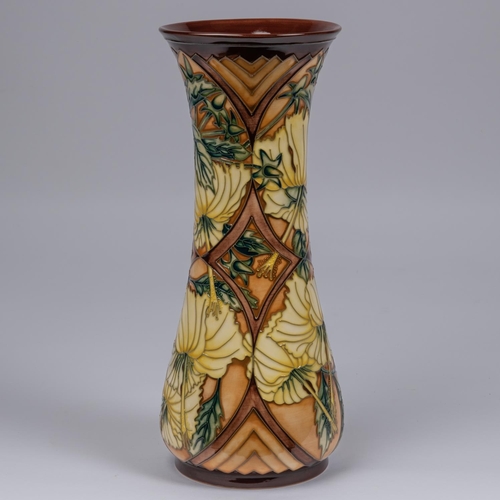 47 - A Moorcroft pottery tall vase. With yellow flowers on brown ground. Impressed marks etc to base, mus... 