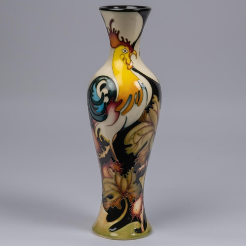 50 - A Moorcroft pottery tall vase. With cockrells on a stylised ground by Kerry Goodwin. Impressed marks... 