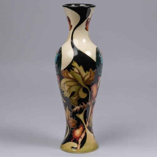 50 - A Moorcroft pottery tall vase. With cockrells on a stylised ground by Kerry Goodwin. Impressed marks... 