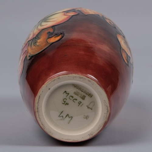 52 - A Moorcroft pottery vase. Galdioli type blooms on a graded ground. Marks to base, GP, bell date cyph... 