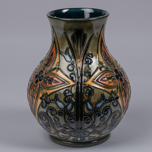 54 - A Moorcroft pottery vase. Abstract foliage designs on a green ground. Marks to base, iron date cyphe... 