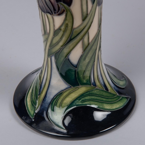 57 - A Moorcroft pottery vase. Tulips on a cream and dark blue ground by Rachel Bishop. Marks to base, AY... 